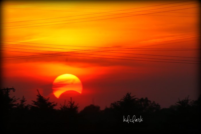 Sunset during a partial solar eclipse by Diane