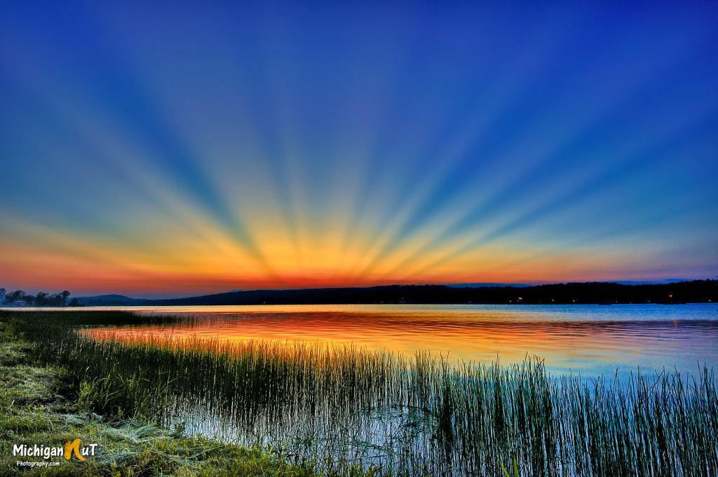 Crepuscular rays over Sunday Lake by Michigan Nut Photography