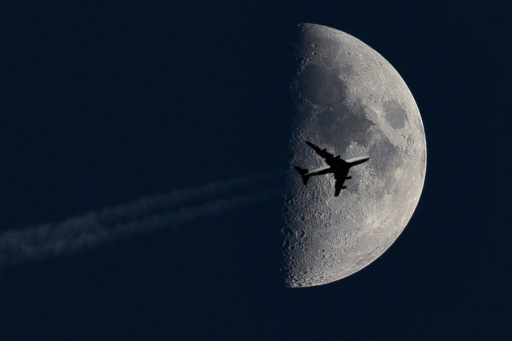 Airplane passing the moon by Saad M.N.B.